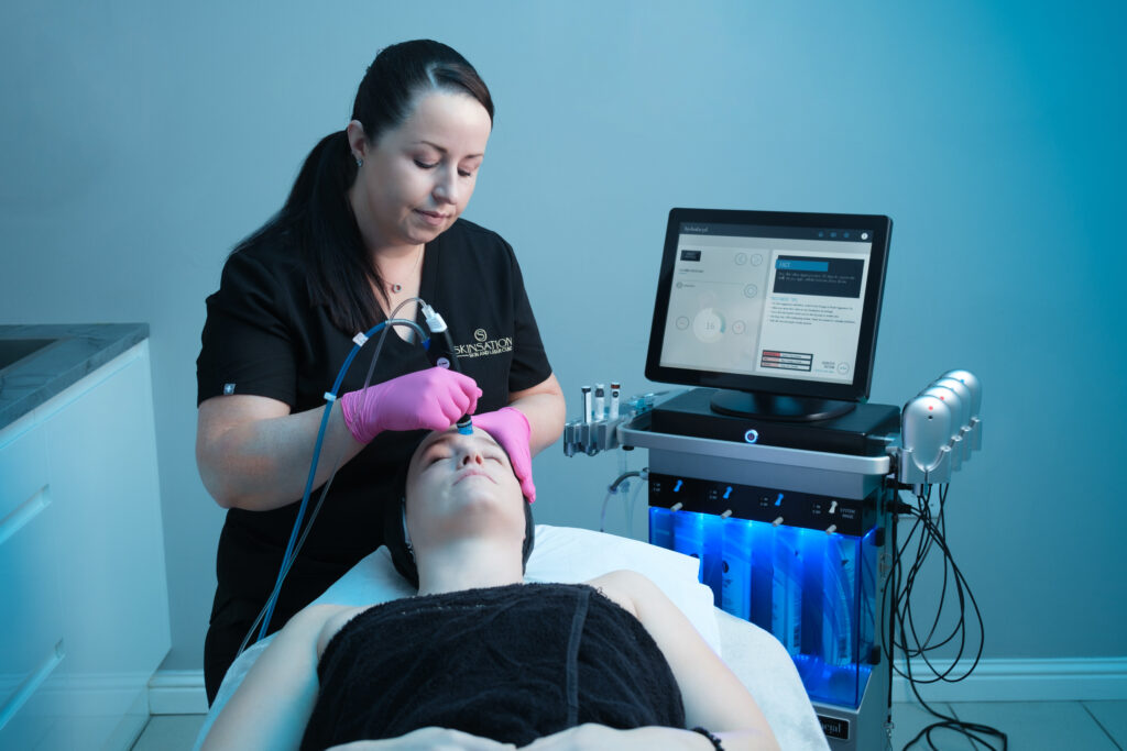 performing Hydrafacial Treatment on client face